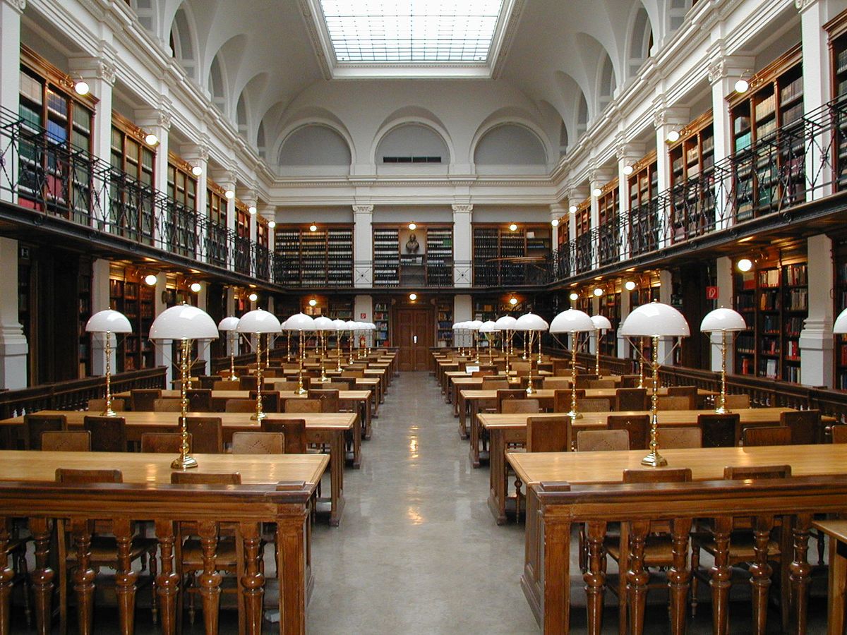 Expansive main reading hall with rows of bookshelves